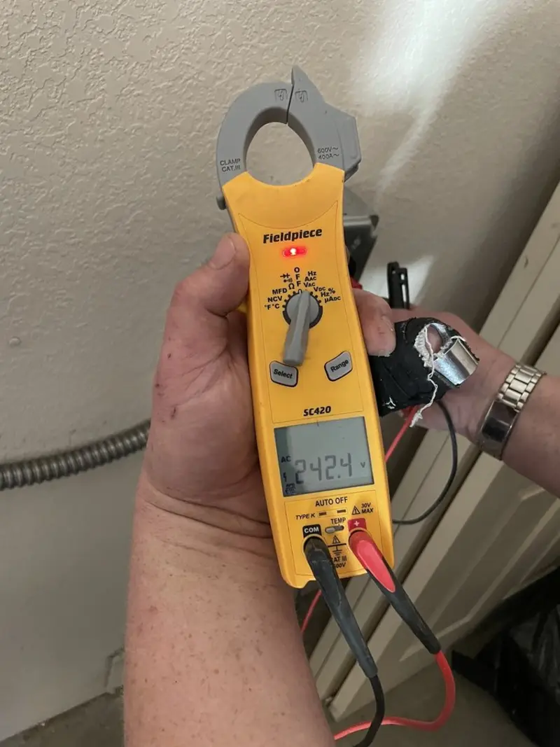 Voltage testing with clamp meter during Electrical Installation Services in Lucas